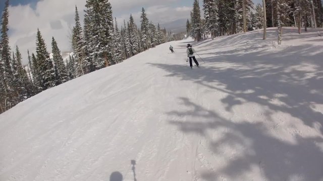 People downhill skiing at a mountain ski resort in Park City Utah shot on a gimbal