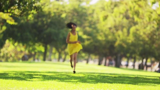 Black woman running towards camera