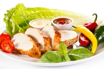 Roast chicken fillet and vegetables on white background 