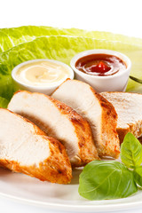 Roast chicken fillet and vegetables on white background 