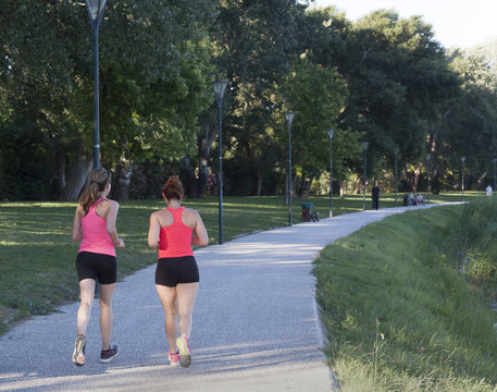 two woman joggin in a park