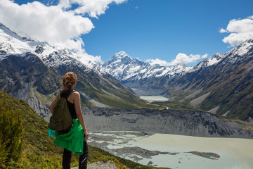 Naklejka na ściany i meble Woman Traveler with Backpack hiking in Mountains