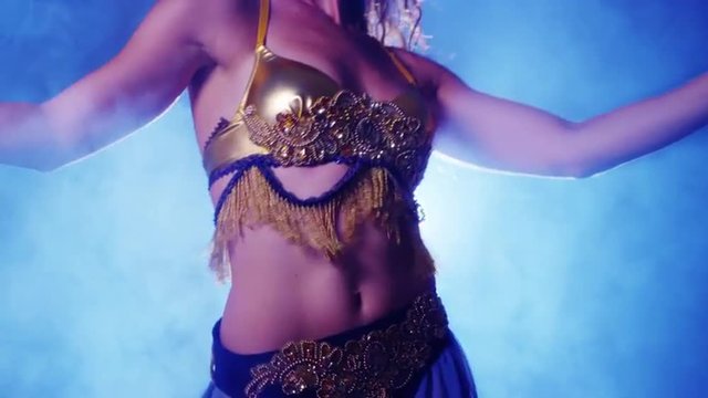 Young woman belly dancer shaking hips