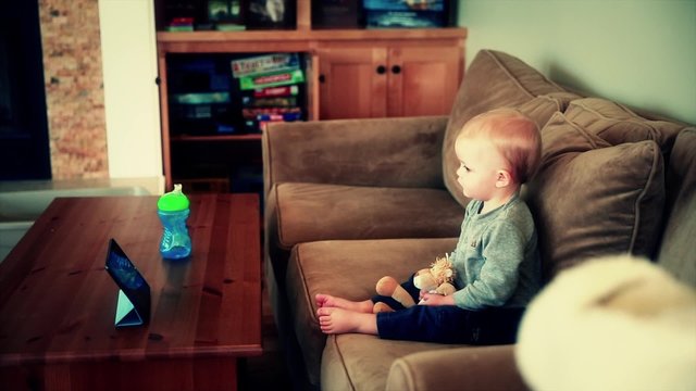 baby boy watching a show on the ipad