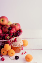 Apricot jam on a background of fruit and berries (apricots, appl
