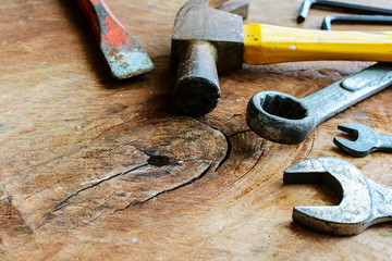 Close up of rusty hammer and tools on old grunge wood