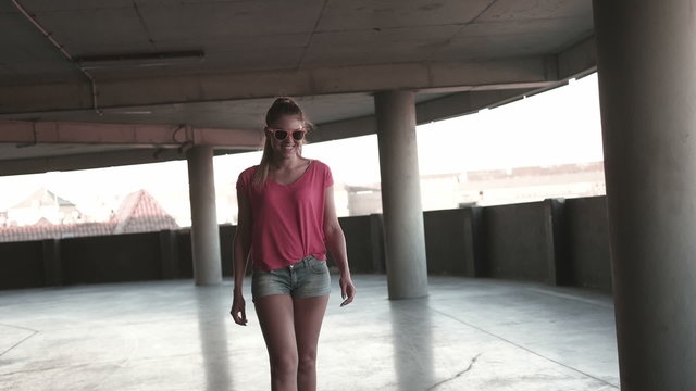 happy attractive young skate girl on the carpark