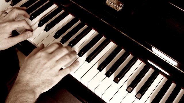 A man plays jazz on a piano