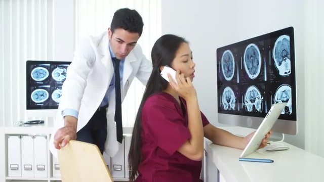Chinese nurse talking on smartphone in office