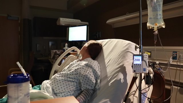 a woman in labor with an iv in her arm for antibiotics