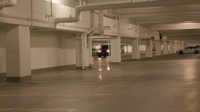 Car driving in parking garage