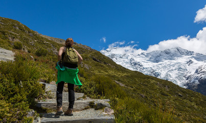 Naklejka na ściany i meble Woman Traveler with Backpack hiking in Mountains