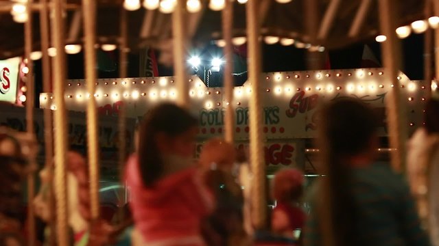 families on a merry go round at night time