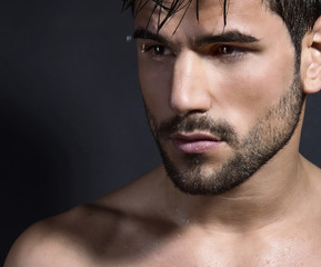 handsome young bodybuilder showing of his fit body and muscles