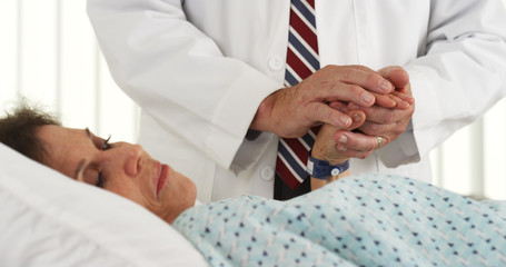Fototapeta premium Senior doctor comforting elderly patient