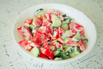 Salad from tomatoes and cucumbers.Selective focus.