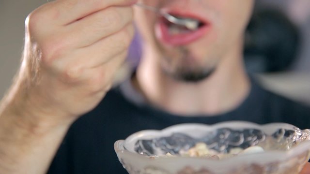 Man Eating Ice Cream From Glass Bowl