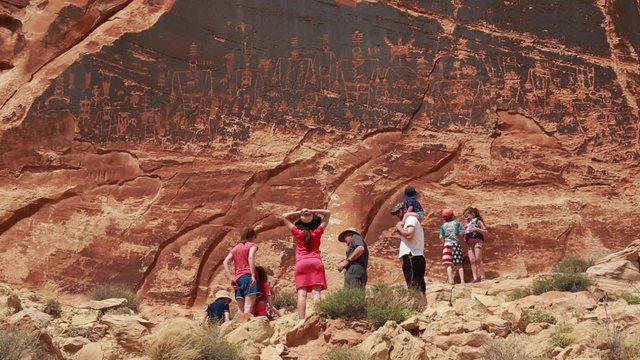 family looking at petroglyphs indian art