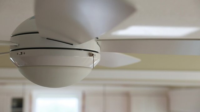 a ceiling fan turned on in the home