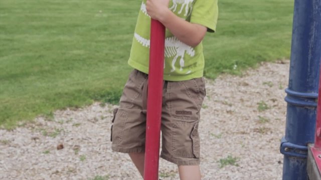 boy playing on playset
