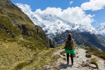 Papier Peint photo Aoraki/Mount Cook Woman Traveler with Backpack hiking in Mountains