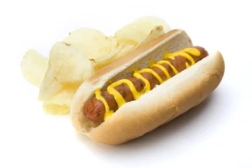 Küchenrückwand glas motiv Hot Dog and Potato Chips – A hot dog in a bun with mustard. Potato chips on the side. © Cathleen