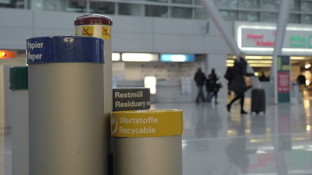 Woman throwing out plastic bottle into recycable bin