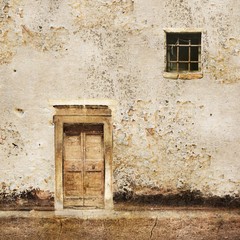 Fototapeta na wymiar Old wall with wooden door and small window