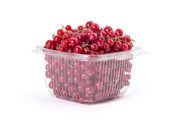 Box or punnet of fresh ripe organic red currants on a white background