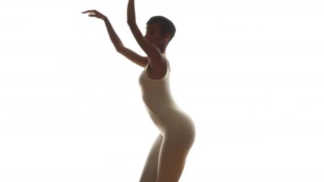 Black woman in white singlet dancing in slow motion on white background