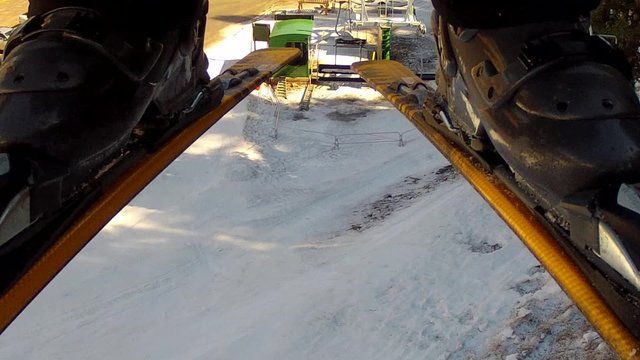 skis and boots riding up lift
