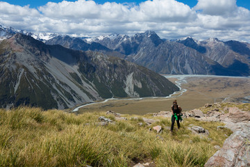 Fototapeta na wymiar Woman Traveler with Backpack hiking in Mountains