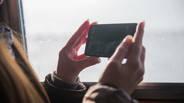 Tourist travel on ship and record with smartphone