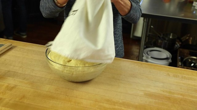 woman letting dough rise to make orange rolls