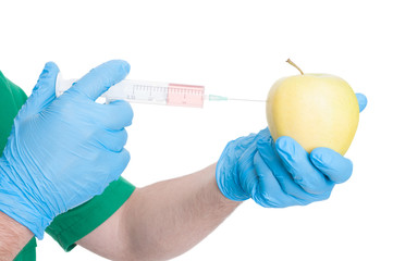 Medic or doctor hands injecting a perfect apple