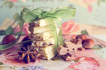 Pile of slices of white chocolate with green ribbon