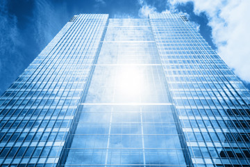 Fototapeta na wymiar Sun reflecting in modern business skyscraper, high-rise building,