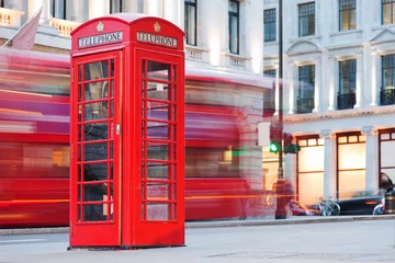 Fotobehang London, UK. Red telephone booth and red bus passing. Symbols of England. © Photocreo Bednarek