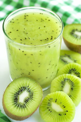 Fototapeta na wymiar Glass of kiwi juice and fresh fruits