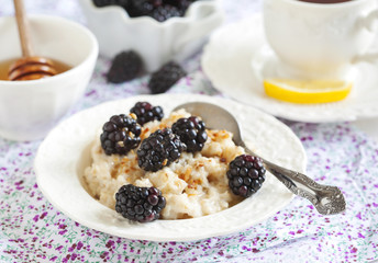 Homemade Oatmeal with Blackberries, granola and honey for Breakf