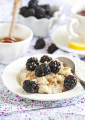 Homemade Oatmeal with Blackberries, granola and honey for Breakf