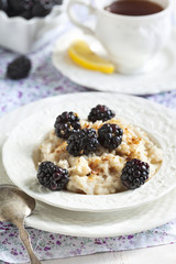Homemade Oatmeal with Blackberries, granola and honey for Breakf