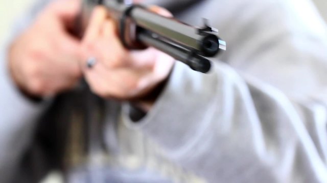 a gunman holding a rifle