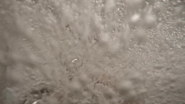 hot tob with bubbles and a hand in slow motion