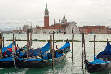 Gondolas moored in the Venice lagoon, with the "San Giorgio Maggiore" island in the background