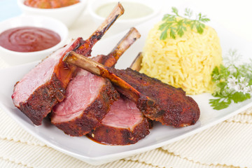 Lamb Cutlets - Spicy roasted lamb cutlets served saffron rice, salad and dips.