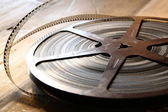 top view image of old 8 mm movie reel over wooden background