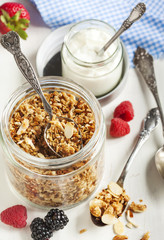 Homemade granola in glass jar on wooden table