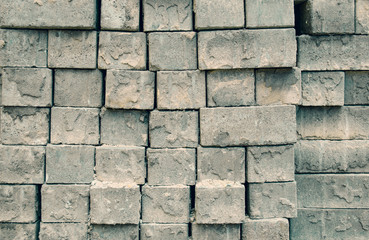 Grey square bricks stacked in rows in the center of city