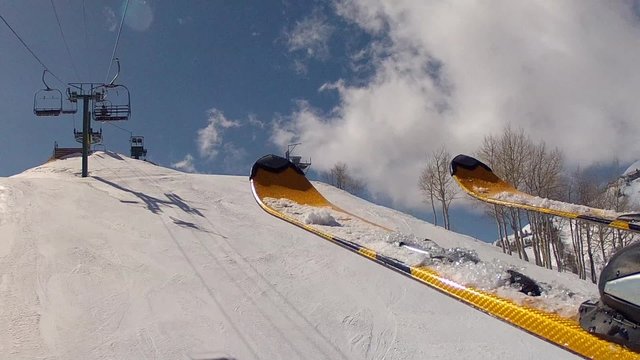 skis riding on a lift